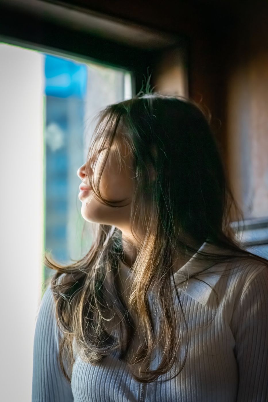 Senior portrait in profile in soft window light
